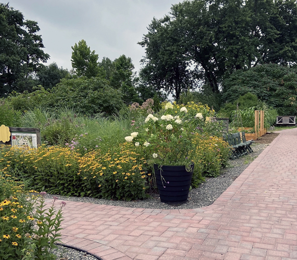 City Green flower garden with accessible pathways made of brick pavers