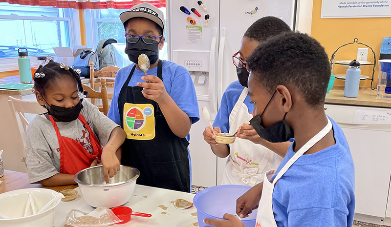 A group of kids learn to cook healthy foods at Hannah's Kitchen