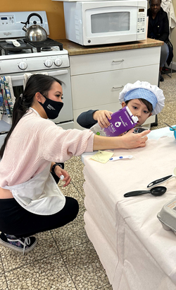A child learns to cook healthy foods at Hannah's Kitchen
